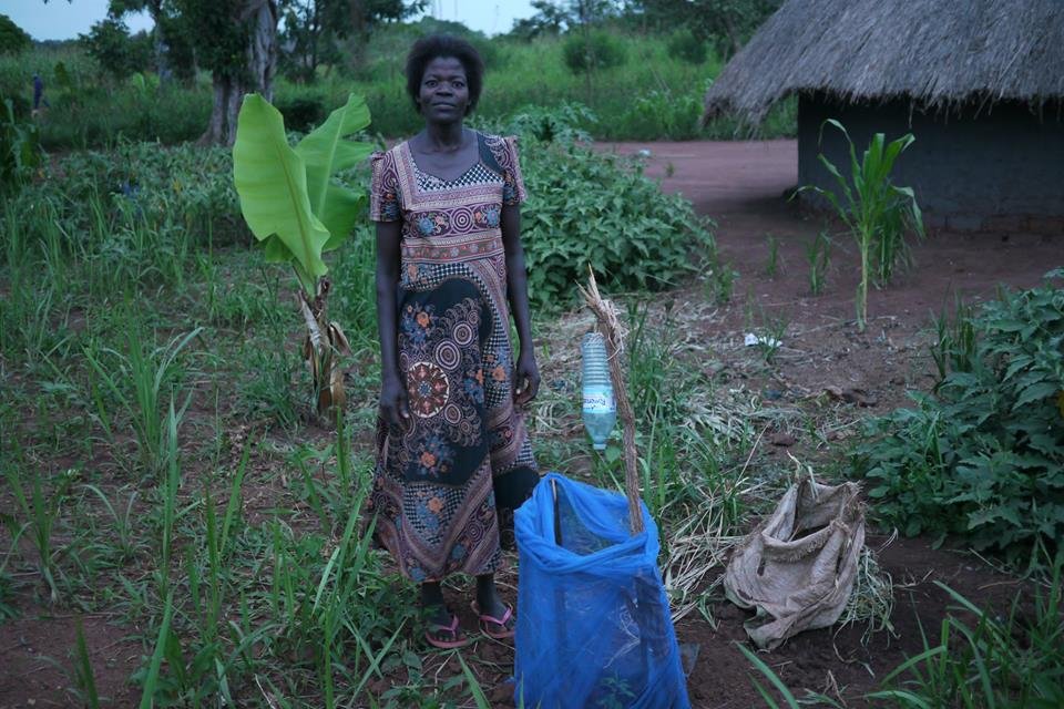 Oromo with a tree seedling she planted